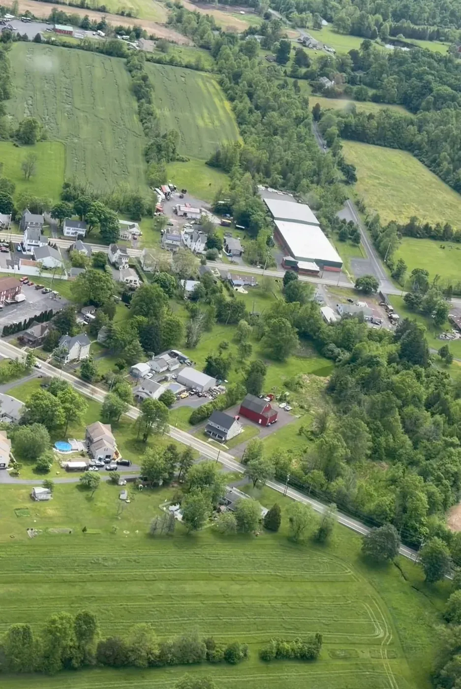 Aerial view of Trumbauersville, Pennsylvania — fields, homes, and tree lines